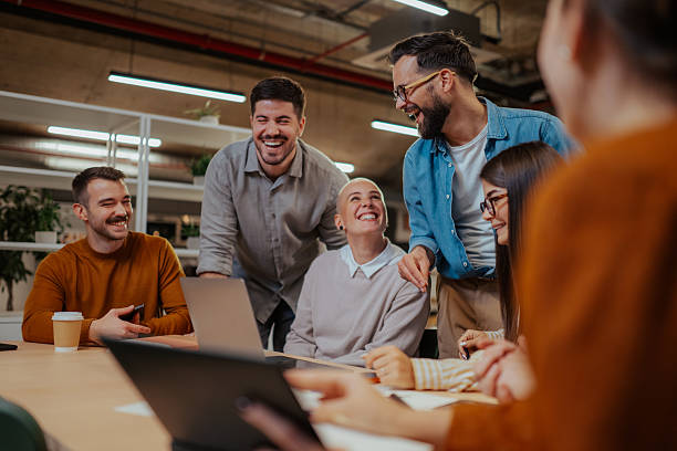 istock Happy diverse business team collaborating and laughing in office 2246064387