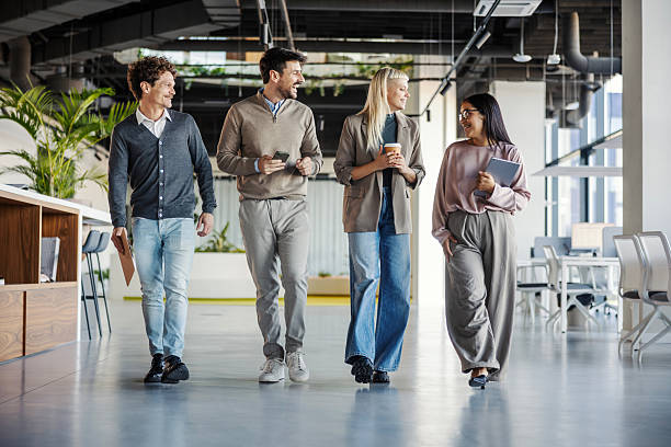 istock Business colleagues walking and talking in modern office 2246065494