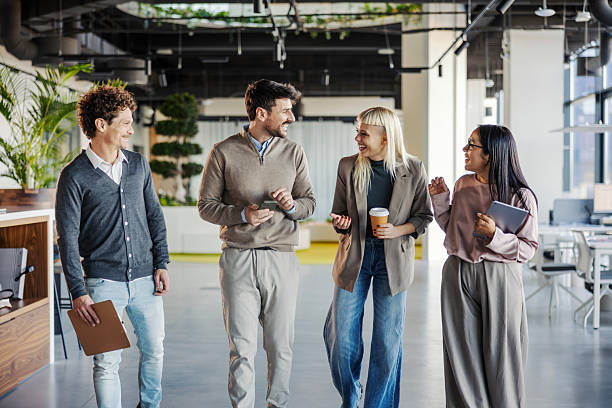 istock Business colleagues walking and talking together in modern office 2246065496