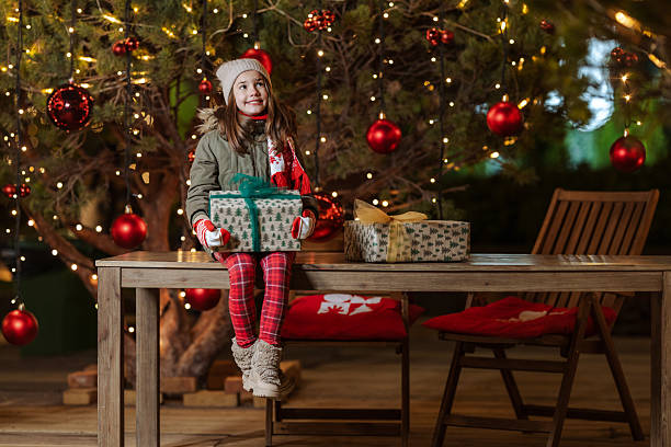 istock Little girl with Christmas present 2246065978