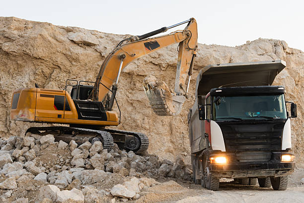 istock Large mining dump truck positioned on a quarry road, surrounded by rocky terrain 2246066262