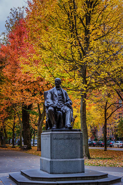 Wooden benches line the Literary Walk in Central Park on an autumn day in New York City.