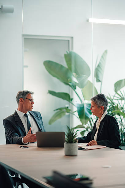 istock Business professional discussing strategy with colleague in office 2246069677