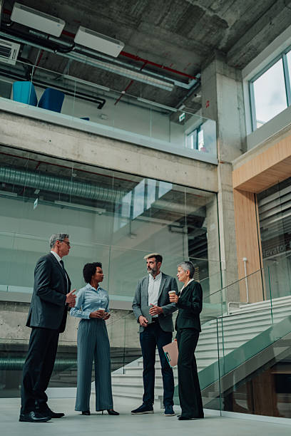 istock Business colleagues discussing work in modern office building 2246069748