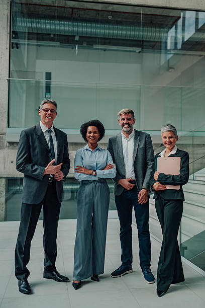 istock Diverse business team smiling in modern office lobby 2246069754