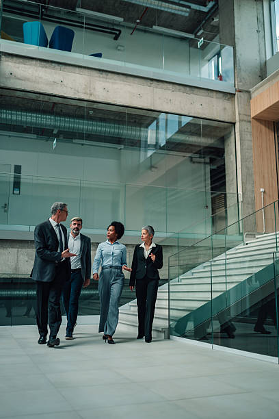 istock Diverse business professionals walking and talking in modern office 2246069787