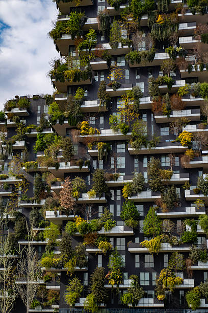 istock Green building with trees represents modern architecture in Milan. Bosco Verticale skyscraper. Sustainable architecture. Vertical forest tower in Italy. Modern apartments by greenery. 2246070579