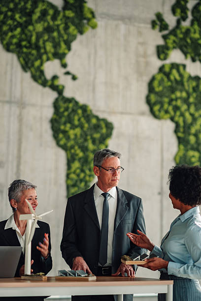 istock Business people discussing renewable energy global solutions 2246070582
