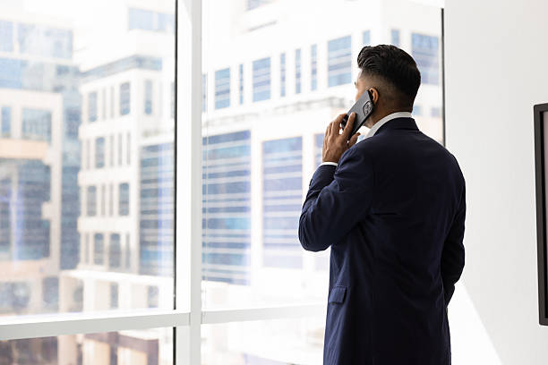 istock Ambitious confident young business owner talking on mobile phone 2246071216