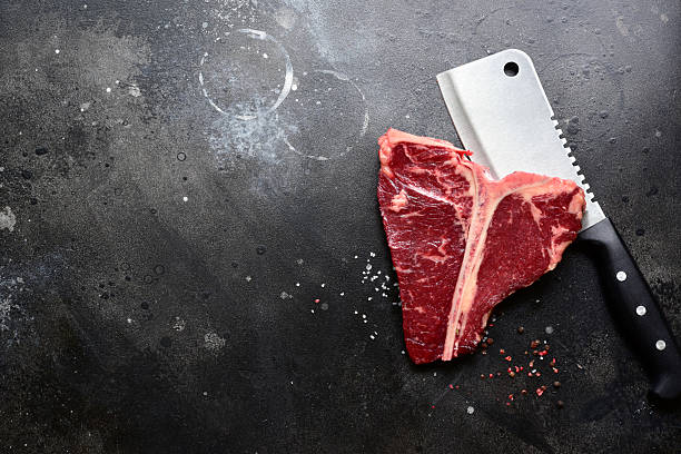 istock Raw organic T-bone steak with spices. Top view with copy space. 2246071645