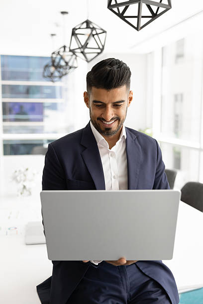 istock Positive successful young Indian businessman typing on laptop 2246072207
