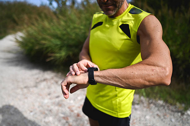 istock Male runner checking smart watch during outdoor workout 2246072694