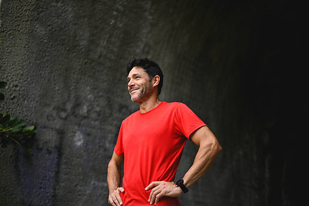 Smiling mid adult man standing with hands on hips after workout