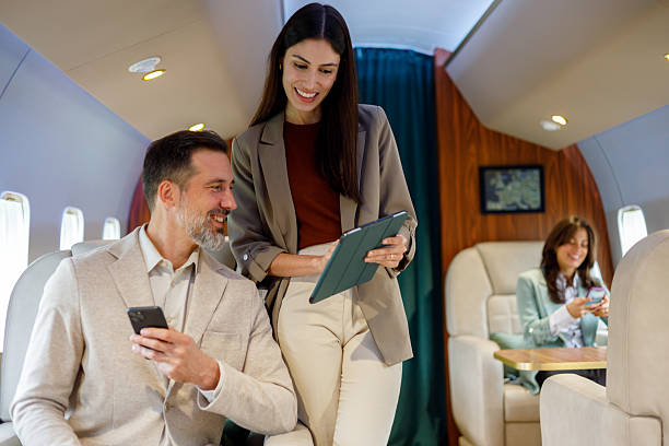 istock Business people collaborating on private jet, working with digital tablet and smartphone during luxurious flight 2246072954