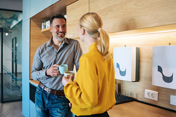 istock Business colleagues enjoying relaxed coffee break in office kitchen 2246074790