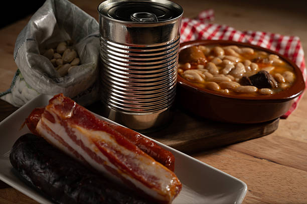 Ingredients for preparing traditional asturian fabada on a wooden table