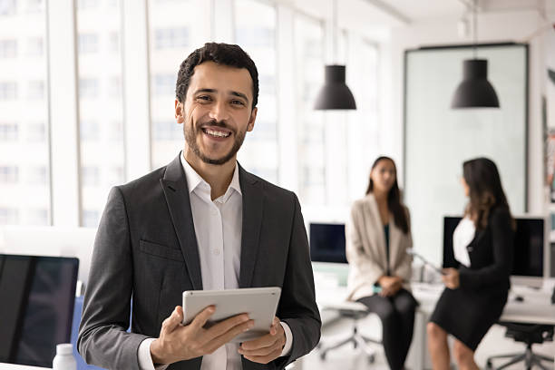 istock Happy young Middle Eastern project manager man holding tablet 2246075508
