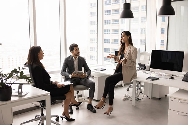 istock Positive professional woman presenting teamwork plan to coworkers 2246076374