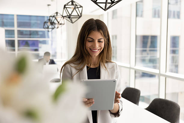 istock Positive focused successful Hispanic businesswoman typing on tablet 2246077864