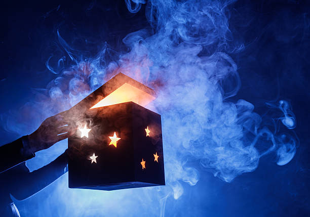 Glowing magic mystery box opening with smoke and stars on blue background