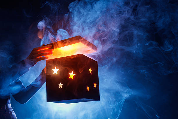 istock Glowing magic mystery box opening with smoke and stars on blue background 2246077986