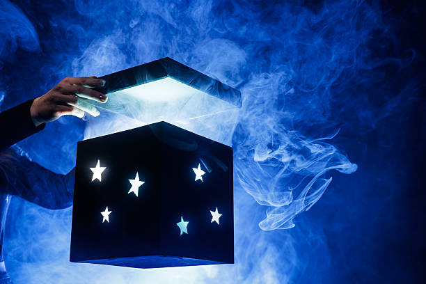 istock Opening glowing magic box with smoke on blue background for mystery gift reveal 2246077993