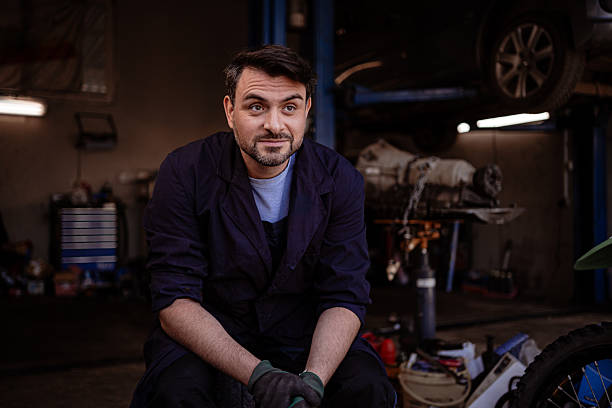 istock Mechanic working at a garage during daytime repairs on motorcycles and vehicles 2246078556