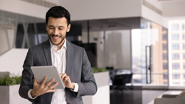 istock Positive young Middle Eastern male professional working with tablet 2246078591