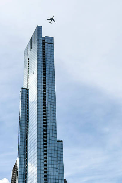 Chicago office building, architecture, cloudy day, airplane flying over. copy space