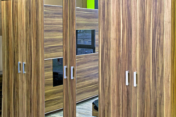 Closed doors at wooden wardrobe with vertical mirrors home interior