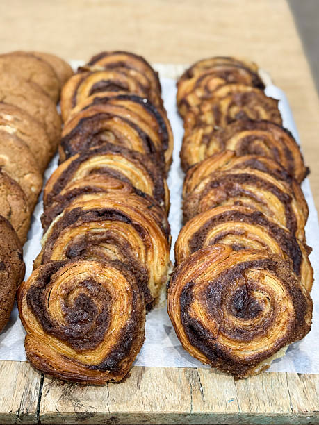 Image of breakfast pastries featuring cinnamon rolls with swirls, freshly baked sweet pastry selection, golden bakery treats