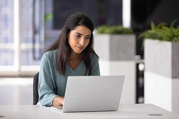istock Busy focused young Latin female professional working on online project 2246080455