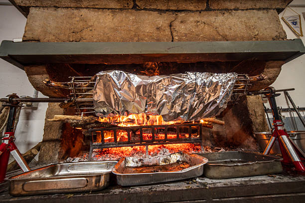 Closeup of camp fire grill with fire flames on dark background.