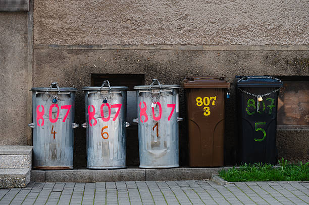 istock Row of numbered garbage bins against wall 2246085009