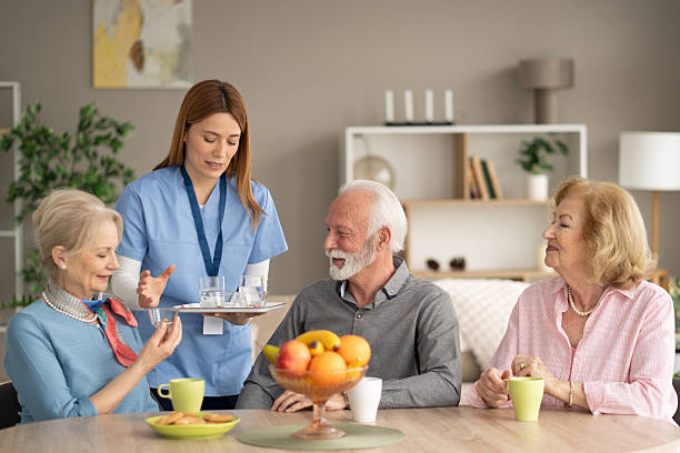 istock Engaging Moment Between Caregiver and Seniors with Drinks 2246086918