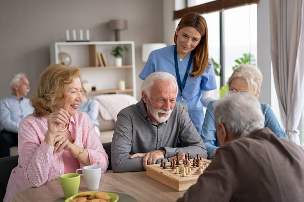 istock Joyful seniors playing chess with laughter and support 2246086949