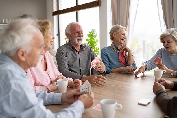 istock Elderly Friends Sharing Joyful Moments Playing Cards Inside 2246086956