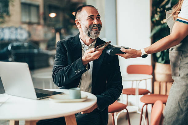 istock Senior businessman making a secure mobile payment 2246087024