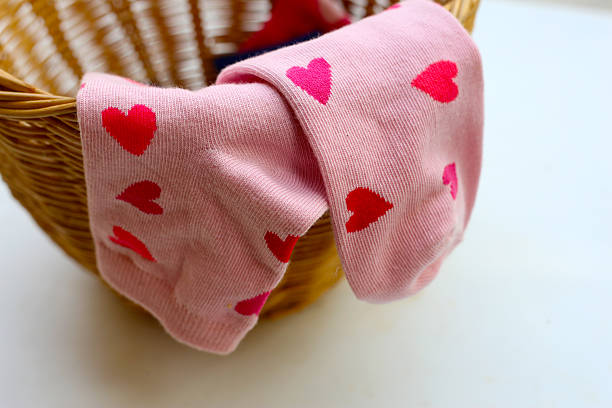istock Colorful socks with heart in a laundry basket. 2246087937