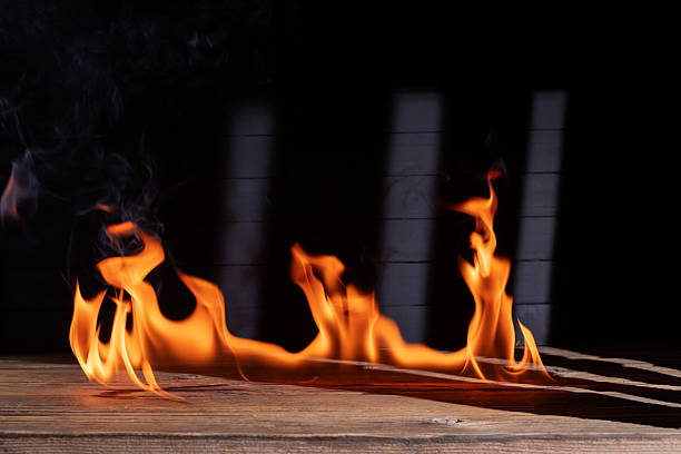 istock Bonfire flames burning on the floor or wooden table on black background. 2246090306