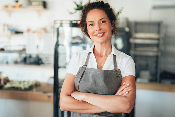 istock Confident bakery and coffee shop owner smiling at camera 2246090419