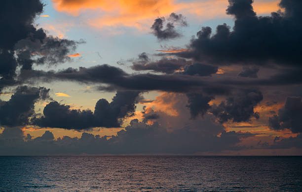istock Dark storm clouds background. Dramatic dark clouds sky. Dark cloudy tropical sky at sunset sea background. Stormy cloudy sky. 2246090545
