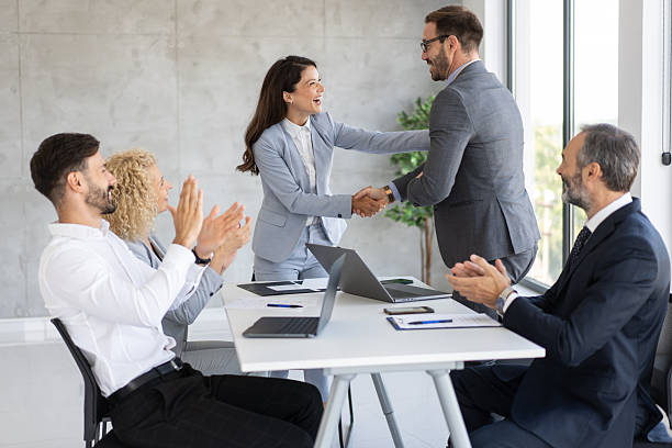 istock Joyful handshake in corporate environment with applause 2246091177