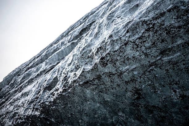 Closeup view of the rock covered with ice. Toned.