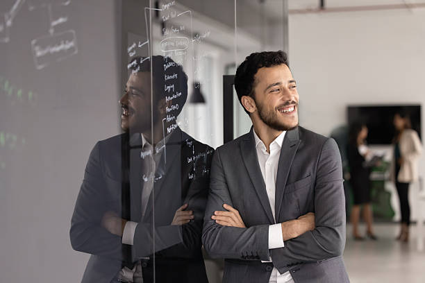 istock Happy young business project manager man standing at glass board 2246095590