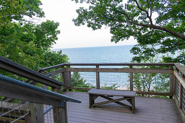 istock Scenic seaside terrace with wooden bench and ocean view 2246097244