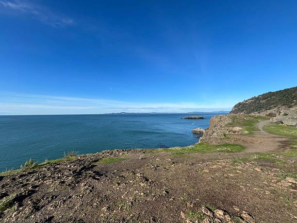 Beautiful coastal view with rocky cliffs and calm blue waters on a clear sunny day