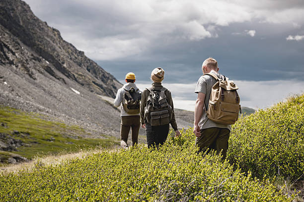 istock Group of three tourists walks in mountains 2246100547