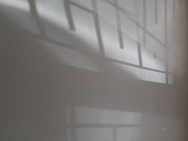 istock Photograph of grey light and shadow on a white concrete wall 2246103278