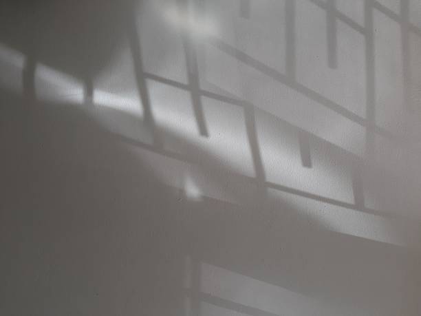 istock Photograph of grey light and shadow on a white concrete wall 2246103295